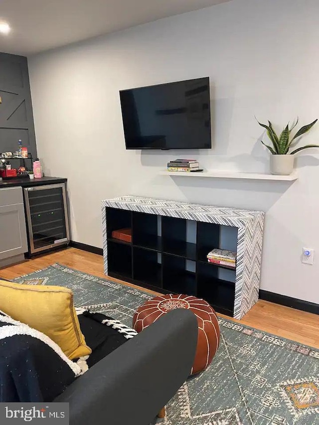 living room with light wood-type flooring and beverage cooler