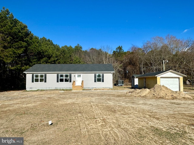 ranch-style house with a garage and an outbuilding