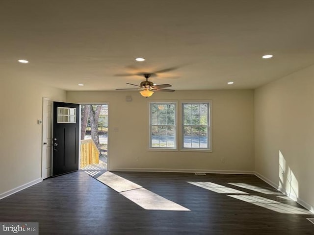 interior space with ceiling fan and dark hardwood / wood-style floors