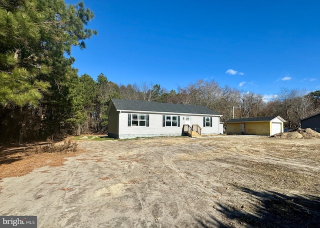 view of front facade with an outbuilding and a garage