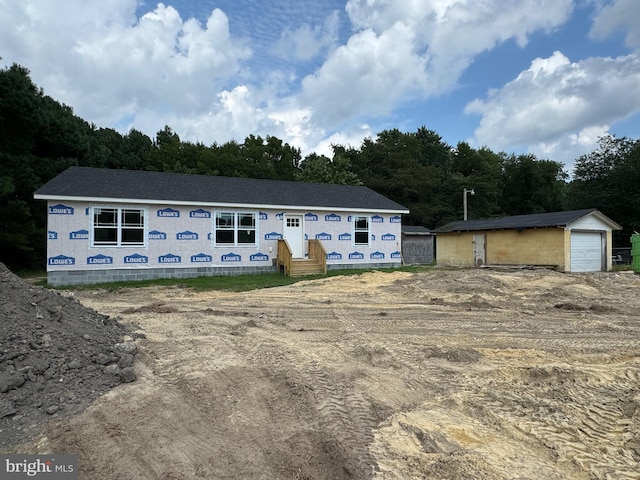 property in mid-construction featuring an outbuilding and a garage