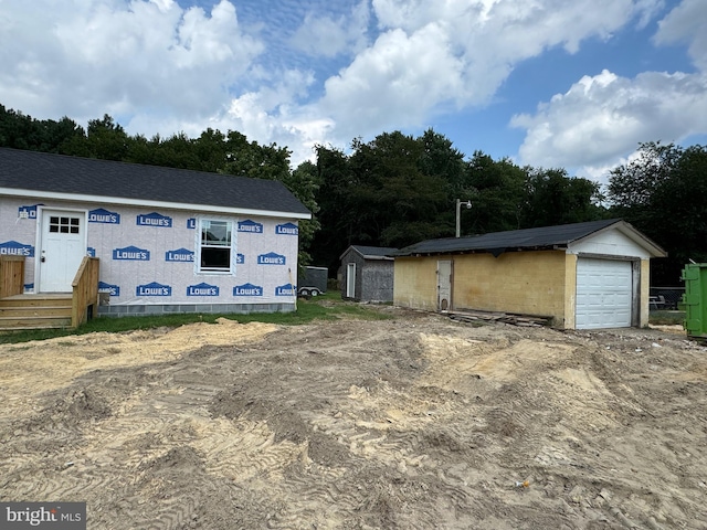 exterior space with a garage and a shed