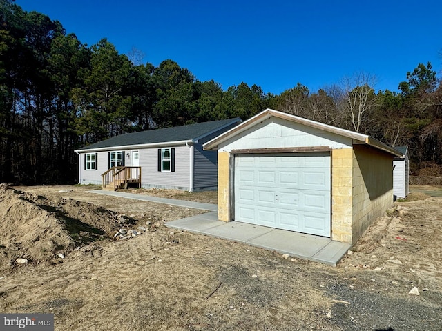 view of front of home featuring a garage and an outdoor structure