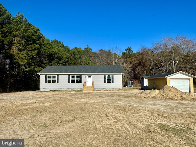 view of front of house with an outbuilding, a garage, and central air condition unit