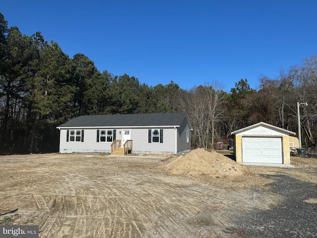 view of front of home featuring a garage and an outdoor structure