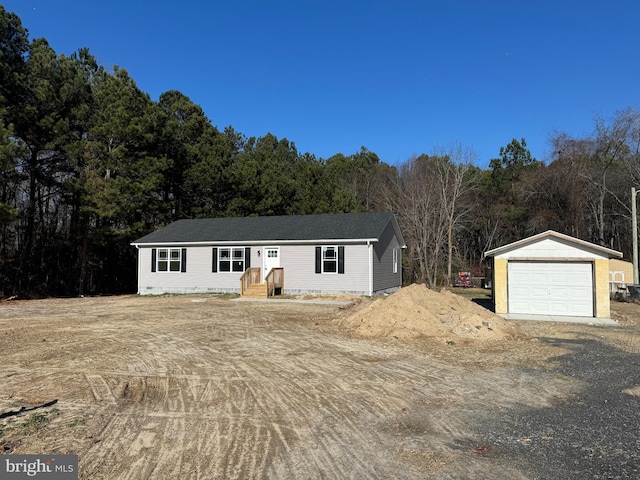 view of front of home with a garage and an outdoor structure