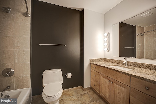 full bathroom featuring vanity, tile patterned floors, tiled shower / bath, and toilet