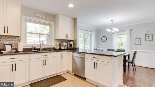 kitchen featuring a healthy amount of sunlight, tasteful backsplash, and kitchen peninsula