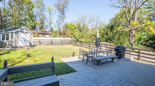 deck featuring a lawn and a shed