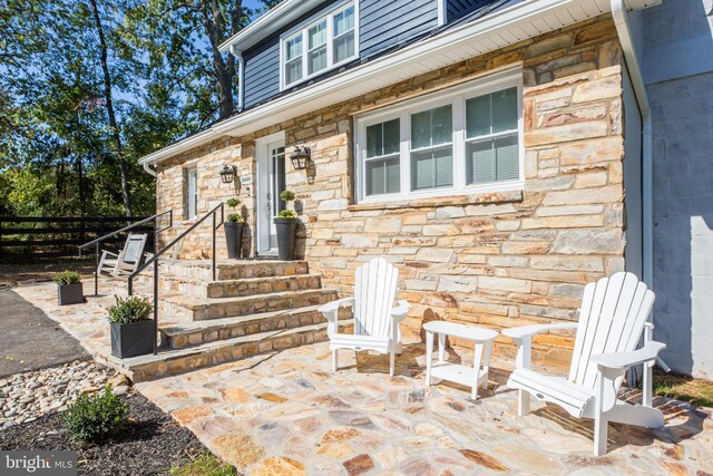 entrance to property featuring a patio area