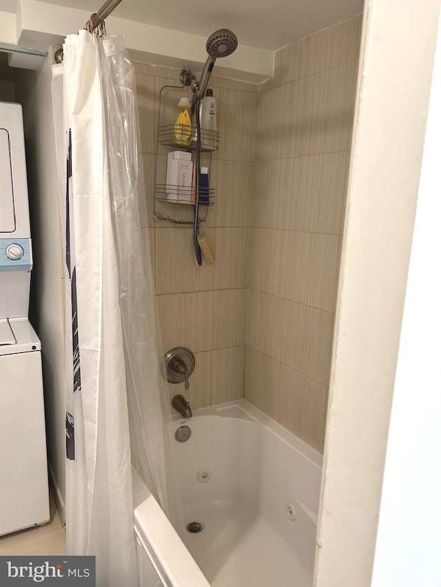 bathroom with shower / tub combo and stacked washer and clothes dryer