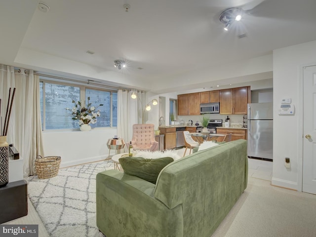 carpeted living room featuring sink