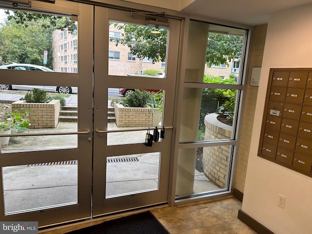 doorway featuring a healthy amount of sunlight, french doors, and light tile patterned floors