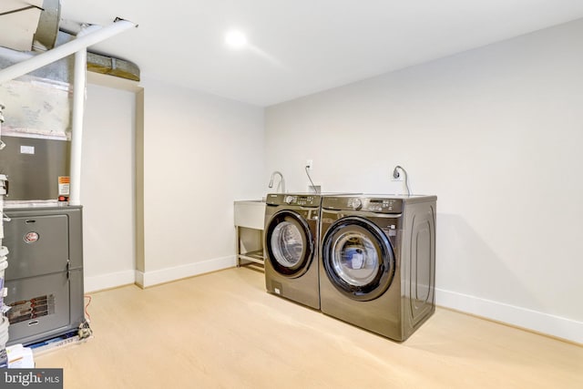 laundry area featuring light hardwood / wood-style flooring and washer and dryer