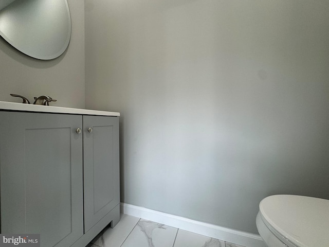 bathroom featuring vanity, tile patterned flooring, and toilet