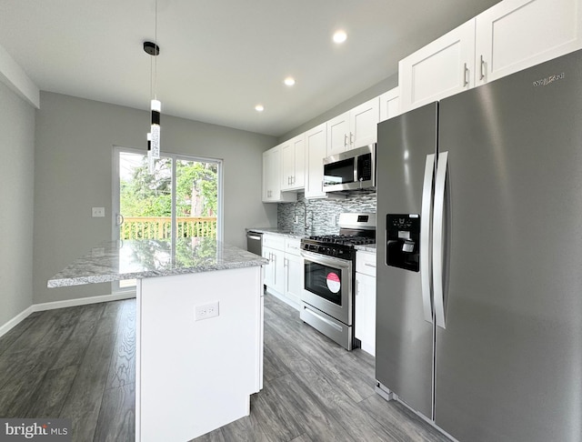 kitchen featuring decorative backsplash, light stone countertops, hardwood / wood-style flooring, and stainless steel appliances