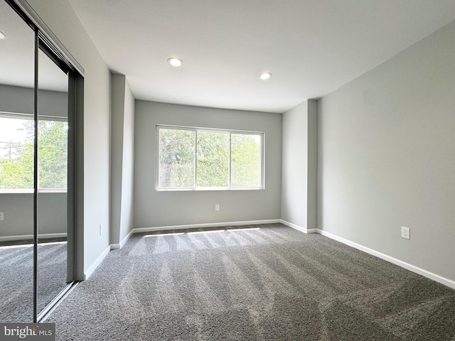 unfurnished bedroom featuring carpet and a closet