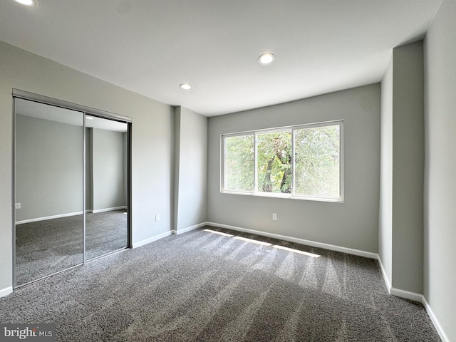 unfurnished bedroom featuring a closet and carpet floors