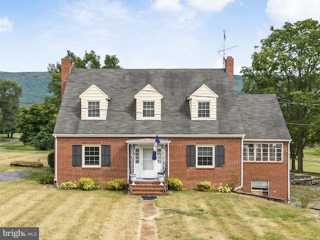 cape cod-style house with a front lawn