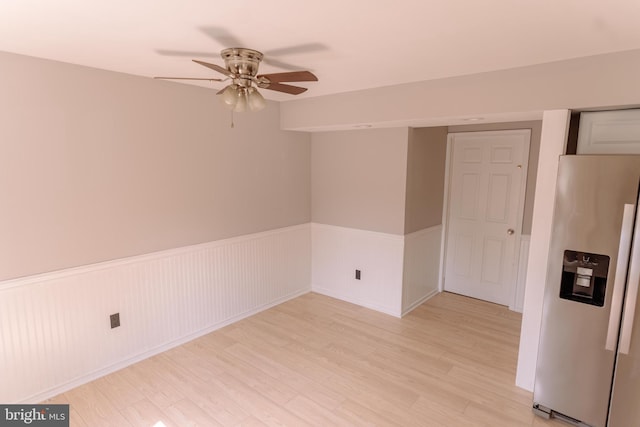 unfurnished room featuring light wood-type flooring and ceiling fan