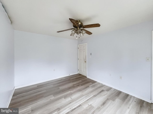 spare room featuring light hardwood / wood-style flooring and ceiling fan