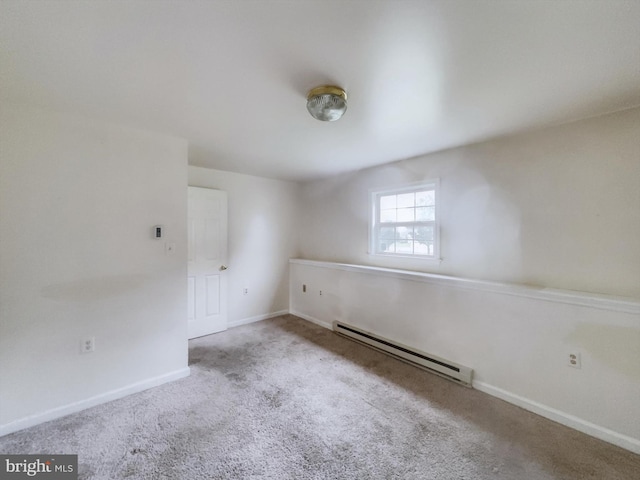 empty room with a baseboard radiator and light colored carpet