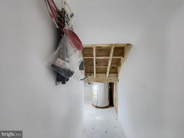 interior details featuring water heater and concrete flooring