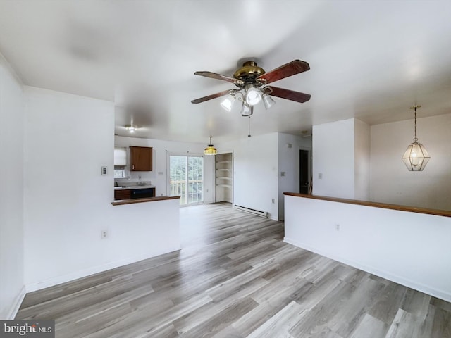 interior space with ceiling fan, light hardwood / wood-style flooring, and baseboard heating