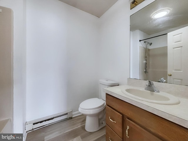 bathroom featuring vanity, walk in shower, hardwood / wood-style flooring, toilet, and a baseboard heating unit