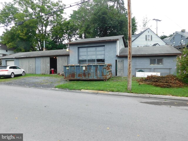 view of front facade featuring an outbuilding and a front yard