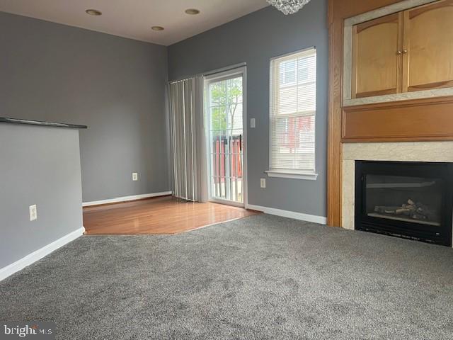 unfurnished living room featuring carpet