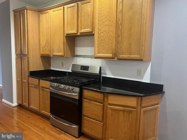 kitchen with light wood-type flooring and stainless steel gas range oven