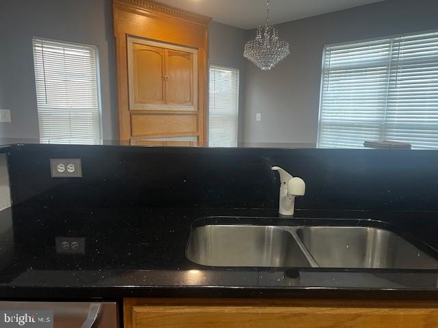 kitchen featuring a chandelier, a wealth of natural light, sink, and hanging light fixtures