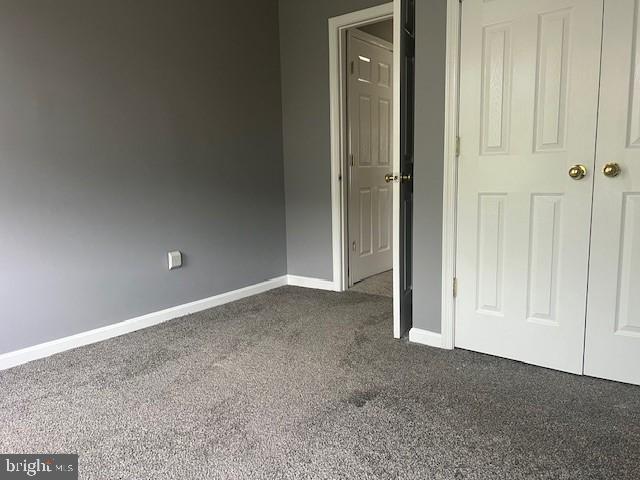 unfurnished bedroom featuring a closet and carpet floors