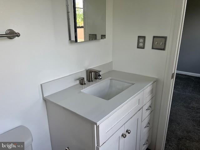 bathroom with vanity and toilet