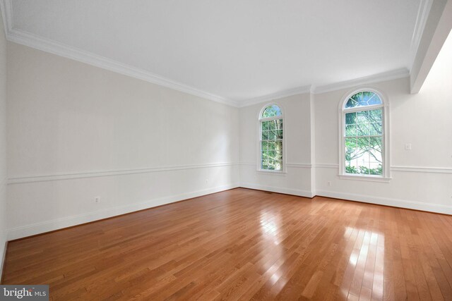 stairway featuring crown molding, a towering ceiling, and hardwood / wood-style flooring