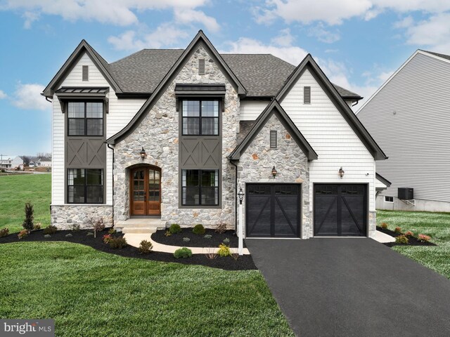 view of front of home with a garage and a front yard