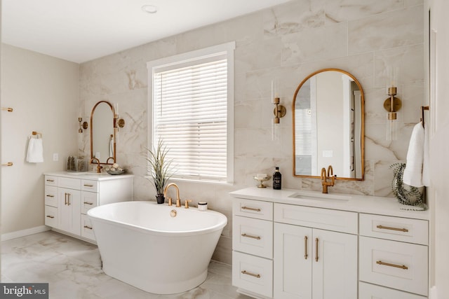 410 Darrow Rd Devonshire, Unit Devonshire, York, PA 17404 - bathroom with tile walls, a freestanding tub, two vanities, marble finish floors, and plenty of natural light