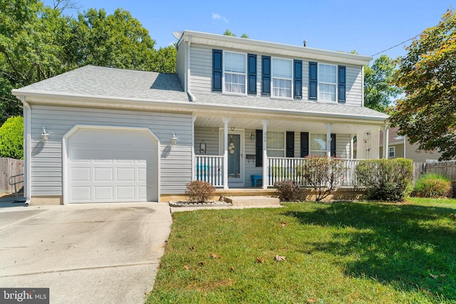 view of front of house featuring a garage, a front lawn, and a porch