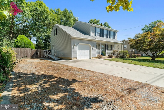 front of property with a front yard, a porch, and a garage