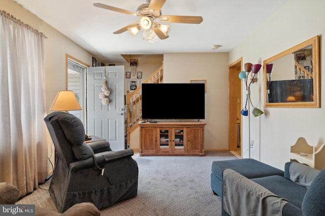 carpeted living room with ceiling fan