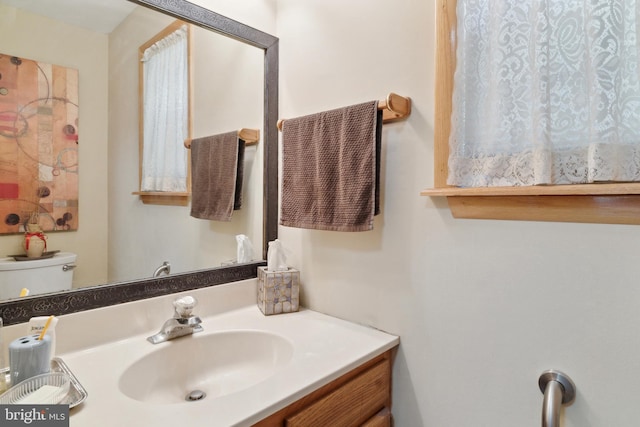 bathroom with vanity and toilet