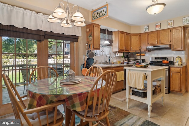 tiled dining area featuring a chandelier