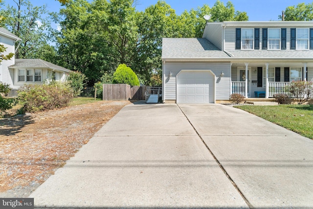 front of property with a porch and a garage