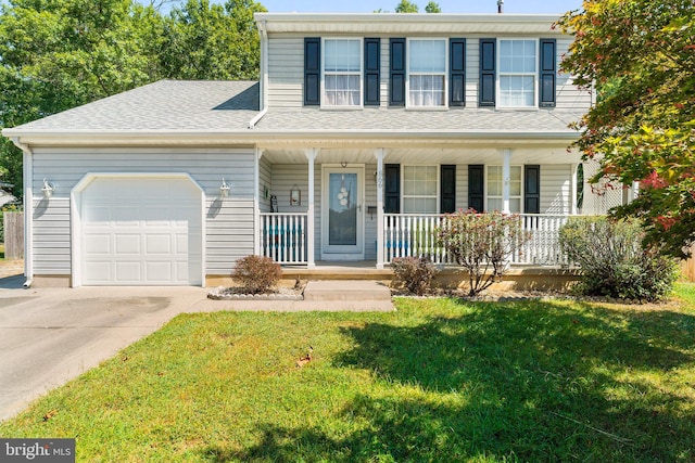 view of front of property featuring a front yard, a garage, and a porch