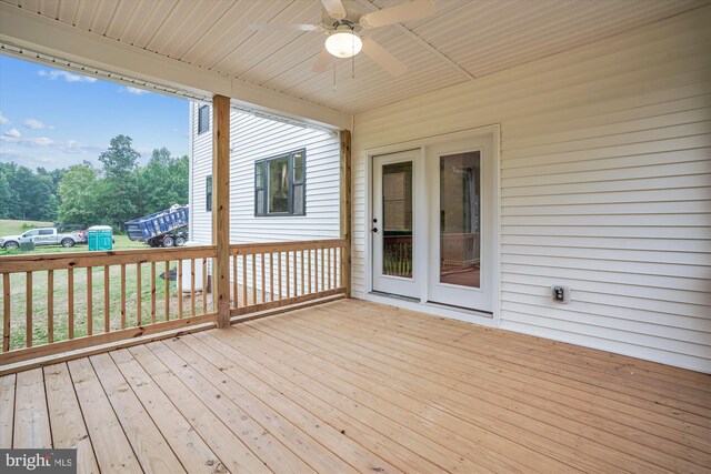 wooden terrace featuring ceiling fan