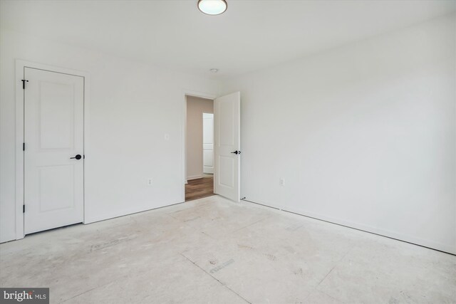 unfurnished bedroom featuring concrete floors