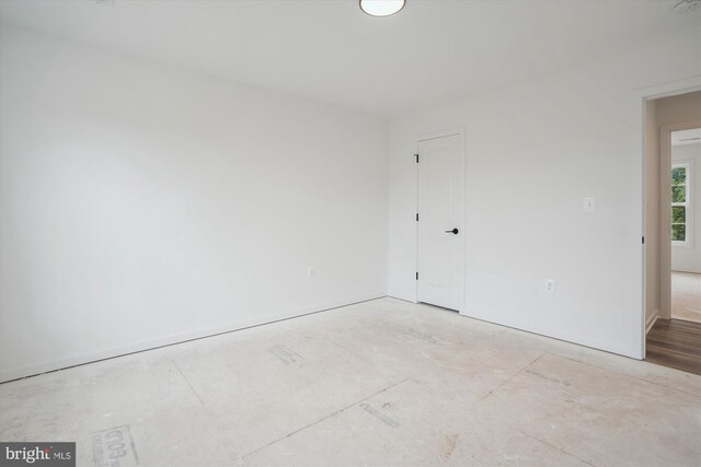 unfurnished room with concrete flooring