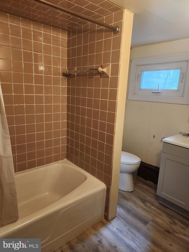 full bathroom with vanity, shower / tub combo, hardwood / wood-style flooring, and toilet