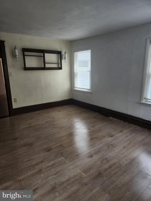 empty room with wood-type flooring